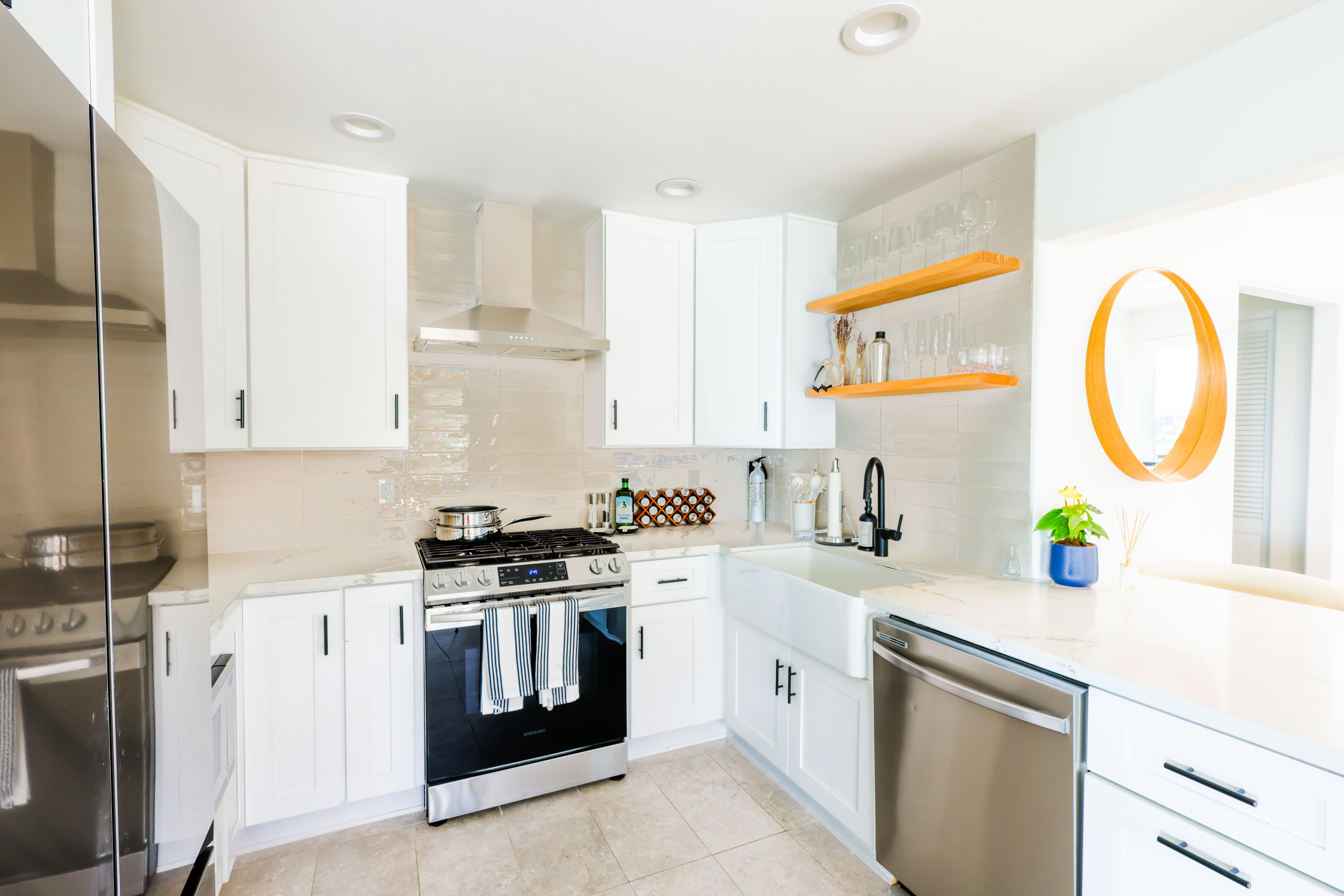 Bright white kitchen with a marble island and coastal styling